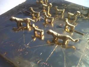 Bag-Chaal. this is a nice one, made of brass. a board game. every child learns to play this in Nepal. is it better to be a tiger? or a goat?