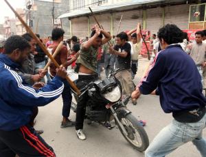 lathis in use. during a bandh. the unfortunate motorcycle driver was attempting to cross a roadblock. 